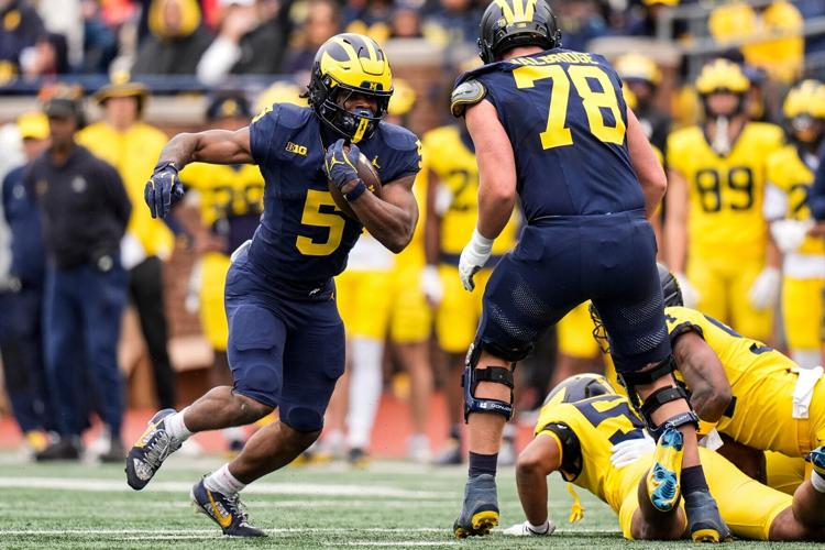 Team Blue running back Savion Hiter (5) runs against Team Maize during the spring game at Michigan Stadium in Ann Arbor on Saturday, April 18, 2026.