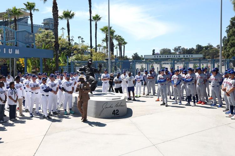 Bob Kendrick, President of the Negro Leagues Baseball Museum, speaks near the Jackie Robinson Statue to the Los Angeles Dodgers and the New York Mets before the game at Dodger Stadium on Wednesday, April 15, 2026, in Los Angeles.