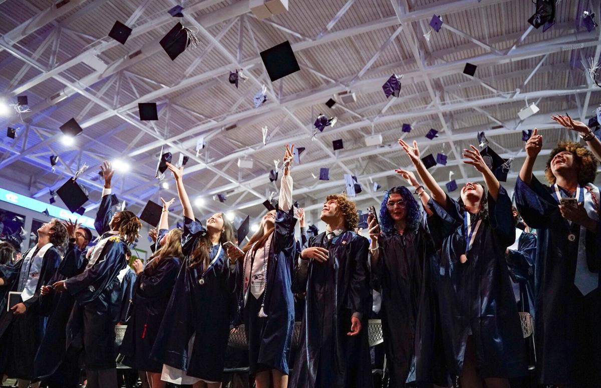 Graduates toss their caps at the end of the Estero High School Class of 2025 commencement ceremony at Suncoast Credit Union Arena in Fort Myers, Fla., on Monday, May 19, 2025.