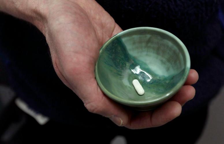 Keith Heinzerling holds a psilocybin capsule at the Pacific Neuroscience Institute.