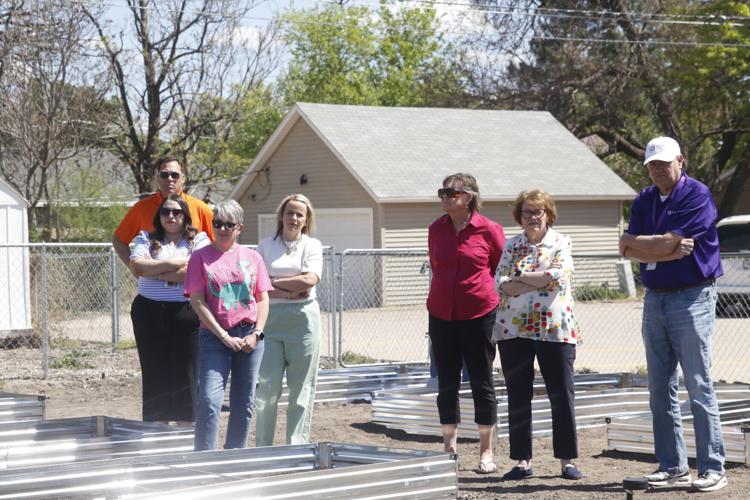Community members listen to speakers at the garden opening