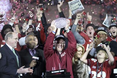 Florida State head coach Jimbo Fisher lifts the BCS trophy after a 34-31 win against Auburn in the BCS Championship game at the Rose Bowl on Jan. 6,.