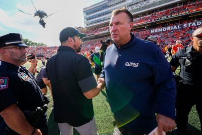 Ohio State Buckeyes head coach Ryan Day shakes hands with Illinois Fighting Illini head coach Bret Bielema following the Buckeyes' 34-16 win in the NCAA football game at Gies Memorial Stadium in Champaign on Oct. 11, 2025.