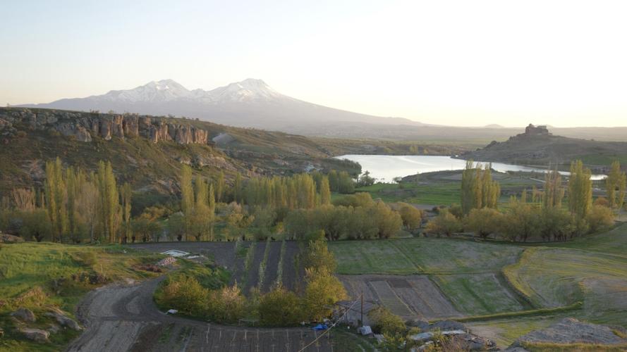 The snowy volcanic slopes of Mount Hasan's double peaks rule the horizon of Cappadocia, keeping watch over Güzelyurt.