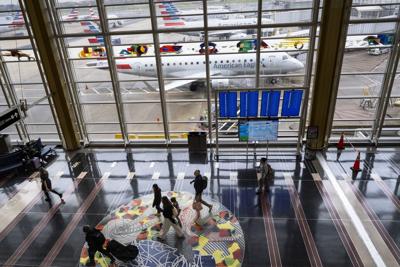 Travelers walk on the main concourse of Terminal 2 at Ronald Reagan International Airport on March 30, 2026, in Washington, D.C. Airports around the country started recovering from long lines as TSA Agents begin to receive their first paychecks after ab...