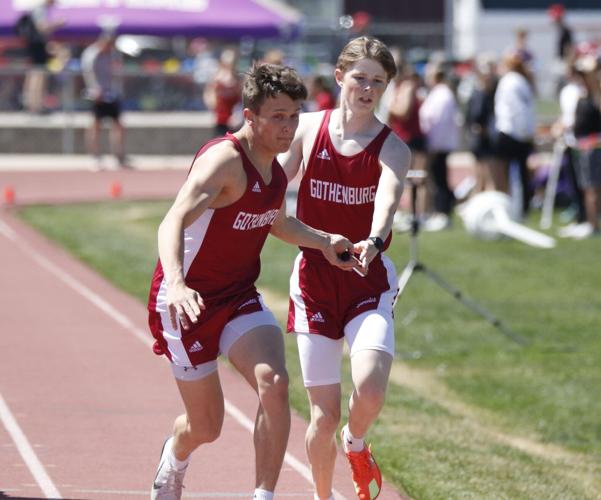 Carson Reiman and Jackson Reidy hand-off in the 4x800