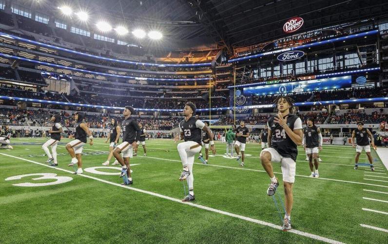 The Miami Hurricanes warmup before the start of the College Football Playoff quarterfinal game against the Ohio State Buckeyes in the Cotton Bowl at AT&T Stadium in Arlington, Texas on Wednesday, December 31, 2025.