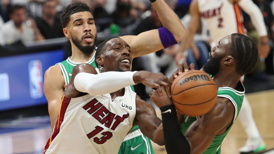 Miami Heat center Bam Adebayo fights for possession of the ball against Boston Celtics forward Jaylen Brown during the first half of Game Seven of the Eastern Conference Finals playoff game at FTX Arena on Sunday, May 29, 2022, in Miami.