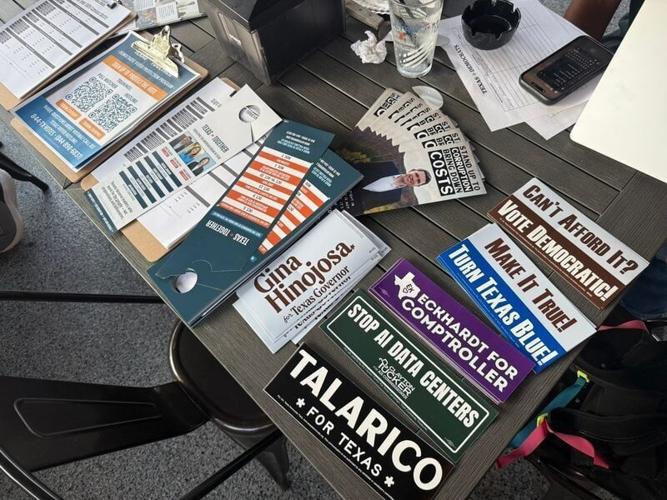 Bumper stickers, pamphlets and voting information is seen at a table during a watch party for Texas Senate Democratic nominee James Talarico's town hall with CNN on Oct. 14 at Mikey's Pizza and Shots in Harlingen, Texas.