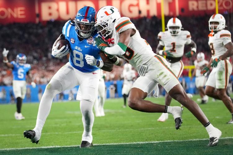 Ole Miss Rebels tight end Dae'Quan Wright (8) scores a touchdown past Miami Hurricanes defensive back Ja'Boree Antoine (16) during their Vrbo Fiesta Bowl matchup at State Farm Stadium on Jan. 8, 2026.
