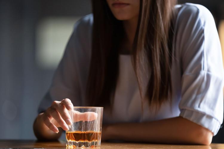 Close up of woman drinking alcohol at bar counter