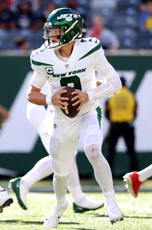 Quarterback Zach Wilson #2 of the New York Jets scrambles with the ball during the fourth quarter against the New England Patriots at MetLife Stadium on September 19, 2021 in East Rutherford, New Jersey.