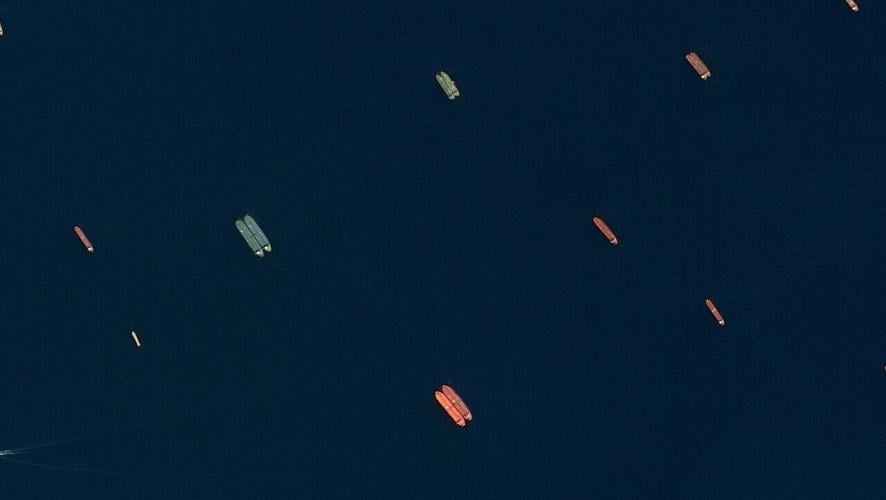 A satellite image of side-by-side ships at sea, off the coast of Sohar