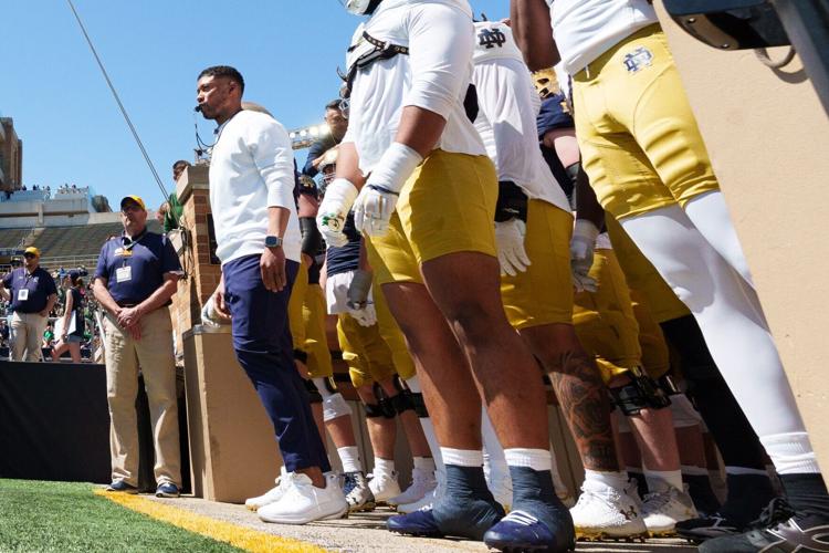 Notre Dame head coach Marcus Freeman, left, waits to lead his team onto the field before the Blue-Gold spring game at Notre Dame