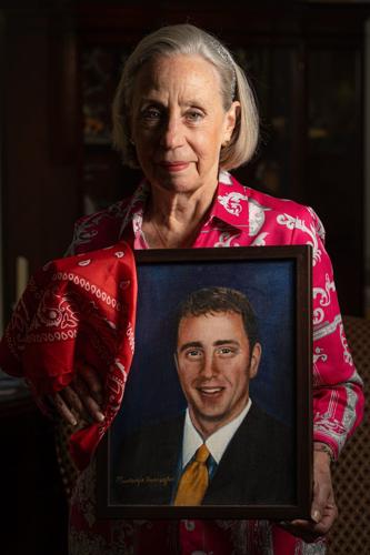 Alison Crowther, photographed Aug. 3, 2026 at her home in Nyack, N.Y., holds a painting of her son Welles Crowther, who has become known as the “Man in the Red Bandana.” Survivors of the Sept 11 attack on the World Trade Center reported seeing a man id