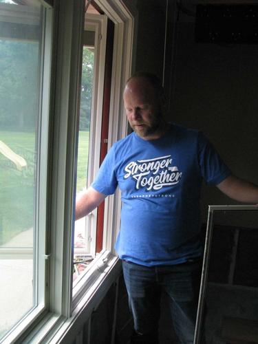 Baer climbing out window