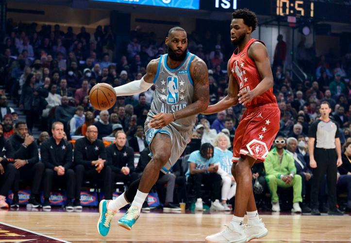 LeBron James of Team LeBron dribbles the ball around Andrew Wiggins of Team Durant in the first half during the 2022 NBA All-Star Game at Rocket Mortgage Fieldhouse on Sunday, Feb. 20, 2022, in Cleveland.