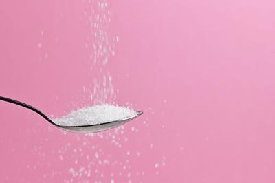 Sugar Pouring From A Spoon