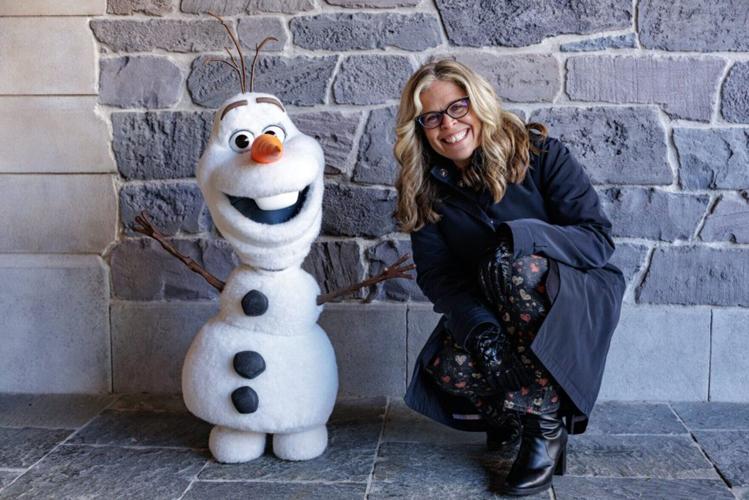 Jennifer Lee, director of "Frozen," poses with an Olaf character during "Disney Worldbuilders," a documentary now showing on Disney+.