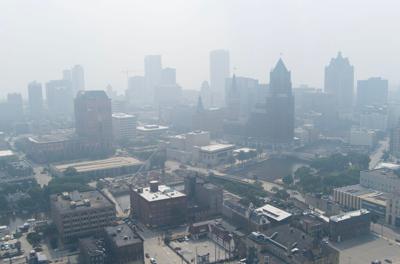 A blanket of smoke fills the air from Canadian wildfires moving south in downtown Milwaukee on July 31, 2025. The Wisconsin Department of Natural Resources issued an air quality advisory for all of the state. The smoke is expected to move back north on Aug