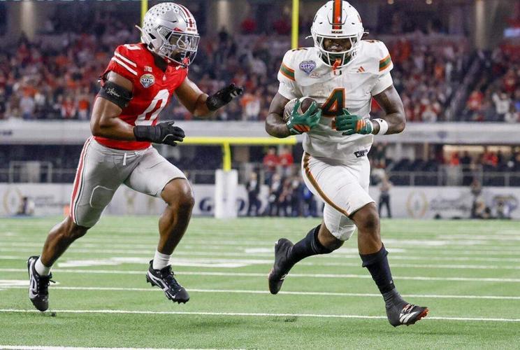 Miami Hurricanes running back Mark Fletcher Jr. runs to score as Ohio State Buckeyes linebacker Sonny Styles defends during the first half of the College Football Playoff quarterfinal game in the Cotton Bowl at AT&T Stadium in Arlington, Texas on Wednes...