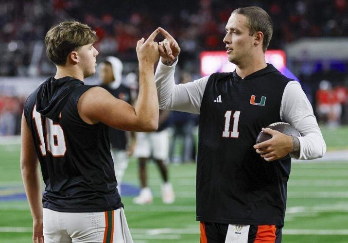 Miami Hurricanes quarterback Luke Nickel and quarterback Carson Beck on the field before the College Football Playoff quarterfinal game against the Ohio State Buckeyes in the Cotton Bowl at AT&T Stadium in Arlington, Texas on Wednesday, December 31, 2025.