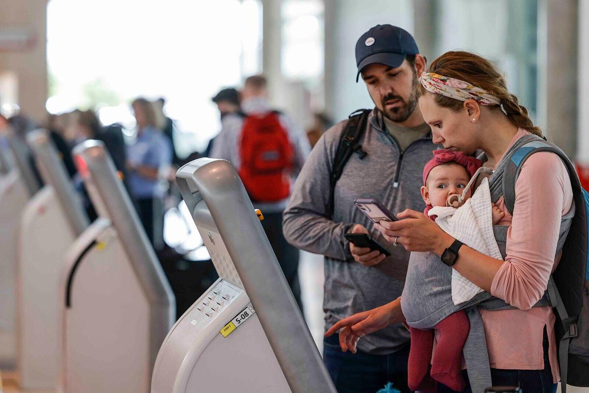 A family checks in for their flight to Nashville at Dallas Love Field Airport in Dallas, Texas.
