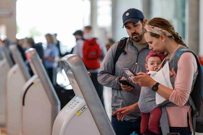 A family checks in for their flight to Nashville at Dallas Love Field Airport in Dallas, Texas.