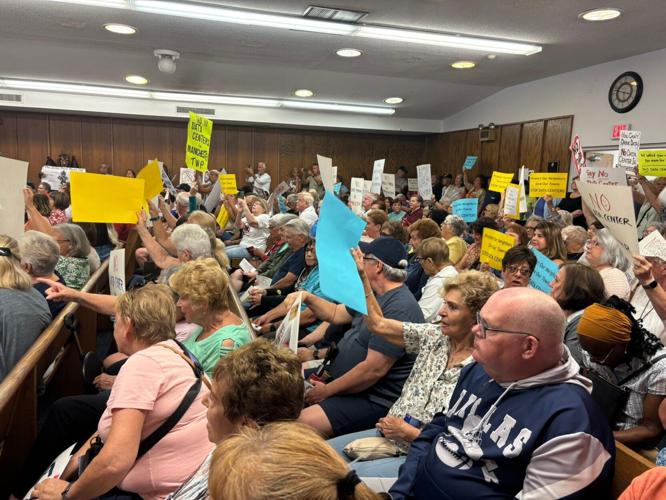 Manchester residents hold signs of protest against data centers during a meeting of the Manchester Township Council on Aug. 24, 2026.