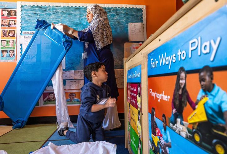Wayne Metropolitan Community Action Agency Mitchell Head Start Center teacher’s assistant Zutsnara Rahman, right, applies a sheet to a cot for a student to take a nap after having a meal in a classroom at the school in Hamtramck on Monday, Oct. 5, 2026.