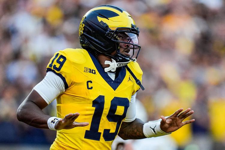 Michigan quarterback Bryce Underwood celebrates after scoring a touchdown against Western Michigan during the first quarter at