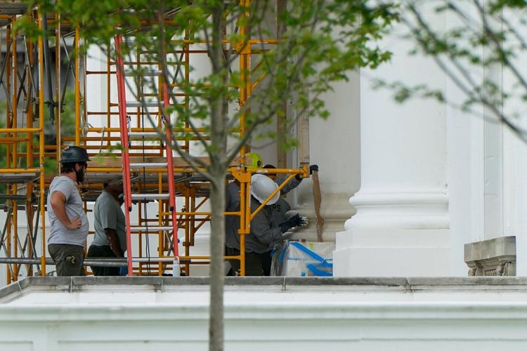 Crews work on North Portico columns at the White House in Washington