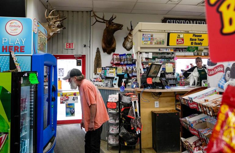 A man checks out lottery tickets at Collins Country Market in Garrison, Kentucky.