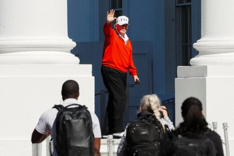 U.S. President Donald Trump waves as he returns to the White House, in Washington