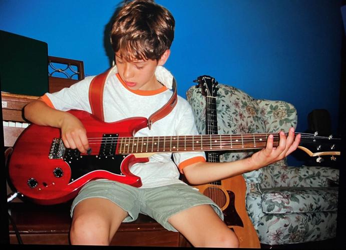Austin Lavicka Luehring plays the first guitar his mother, Christina LaVicka, bought him and taught him lessons on.