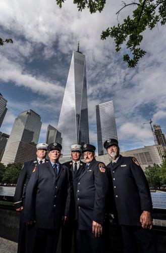 Retired FDNY firefighters John Drumm, Robert Bacon, Jim McGlynn, James Efthimiades, and Jeffrey Coniglio, at the 9/11 Memorial at the World Trade Center Aug 5, 2026. On Sept. 11, 2001, after going back into the North Tower to search for Drumm, the other fo