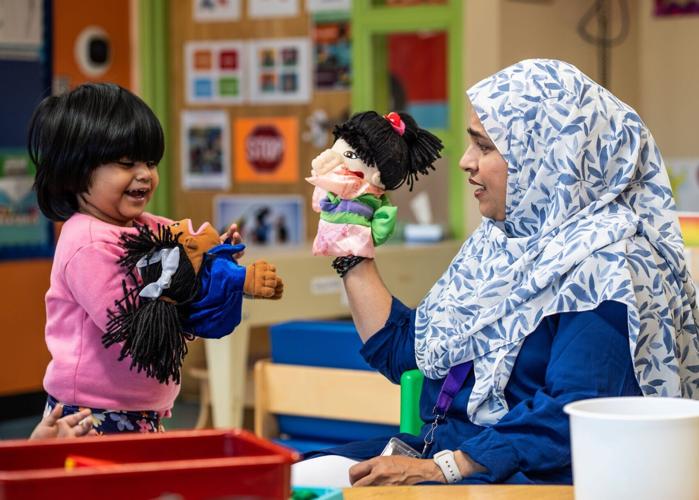 Head Start teachers assistant Zutsnara Rahman, right, uses a puppet with Aliza Ahmed at Mitchell Head Start Center in Hamtramck on Monday, October 5, 2026. In addition to rolling back Head Start program requirements and standards, the Trump administration