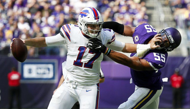 Buffalo Bills quarterback Josh Allen (17) jumps over Minnesota Vikings  linebacker Anthony Barr (55), picking up a first down on the the play in  the first quarter on Sunday, Sept. 23, 2018