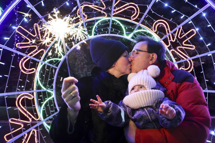 The world begins 2025 with light shows, embraces and ice