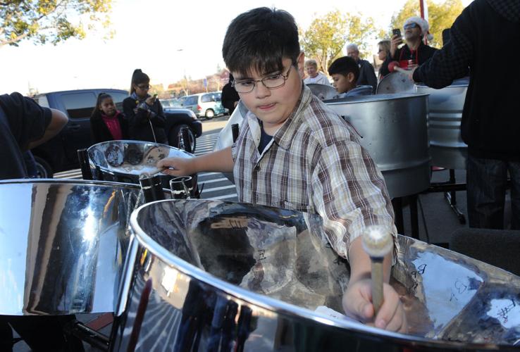 Children play steel drums in concert outside Walmart News