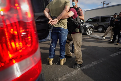 U.S. Immigration and Customs Enforcement agents transfer an immigrant