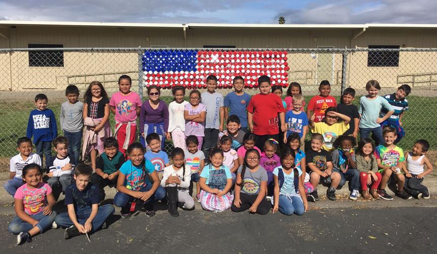Stars and Stripes Fillmore students construct cup flag in front of
