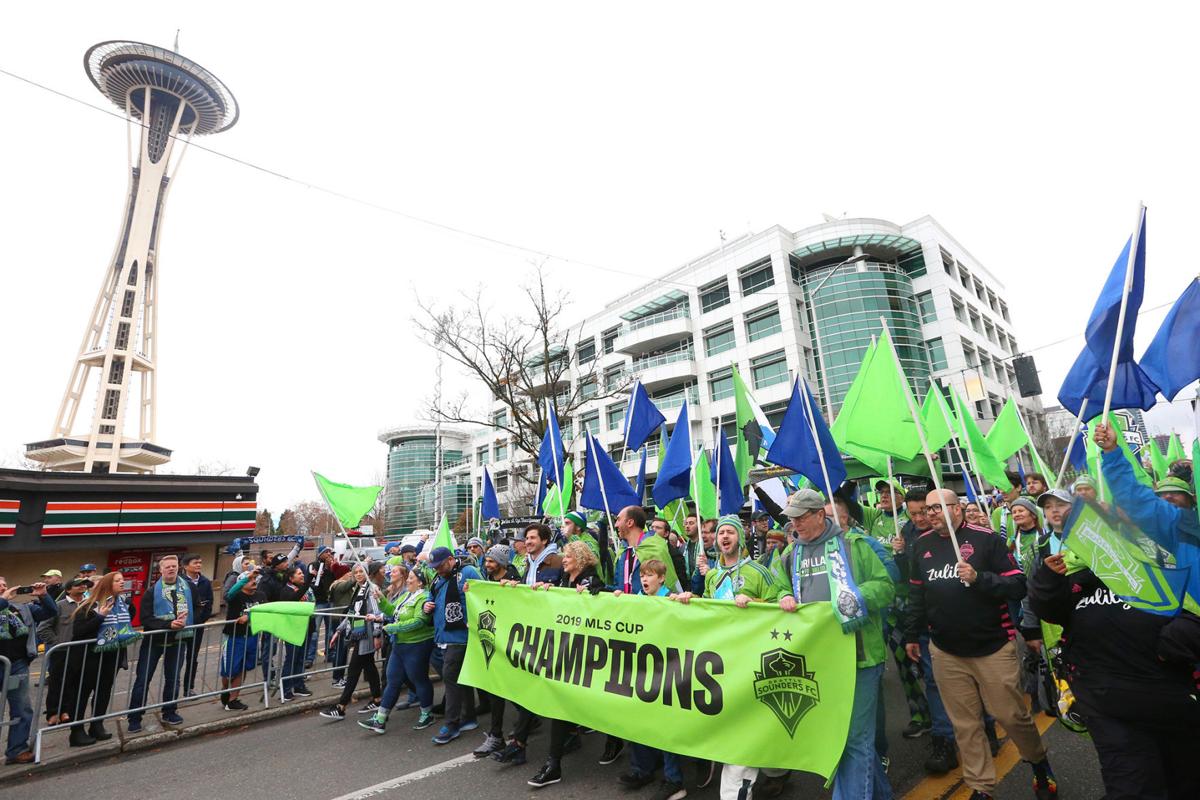 Fans show their support for the Seattle Sounders during the team's MLS Cup victory parade on November 12, 2019, in Seattle.
