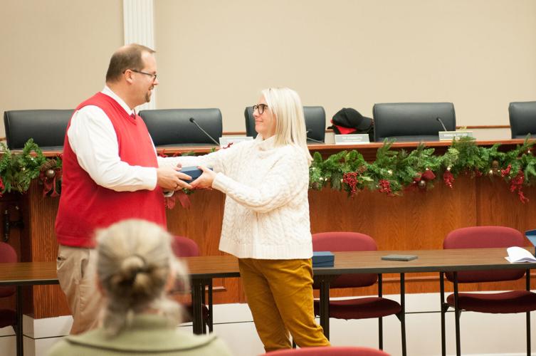 Council member Erin Rayner presents outgoing council member Joel Grewe with a gift at the town council’s last scheduled meeting of year Dec. 13, 2022.