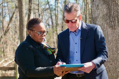 JK Land Holdings President and CEO Chuck Kuhn signs a memorandum of understanding with Loudoun Freedom Center founder Pastor Michelle Thomas that would gift 10 acres to the center—if Dominion Energy moves its planned transmission line.