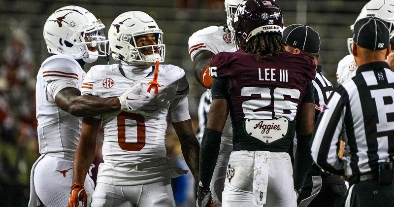 Nov 30, 2024; College Station, Texas, USA; Texas Longhorns receiver DeAndre Moore Jr. (0) gets into a verbal argument with Texas A&M defensive back Will Lee III (26) during the Lone Star Showdown at Kyle Field. Mandatory Credit: Sara Diggins/USA TODAY Network via Imagn Images