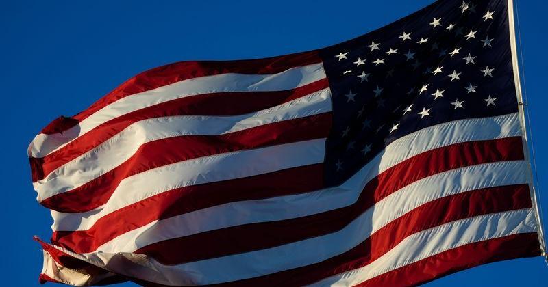 The sun rises on Veterans Memorial Island Sanctuary as the flag flies at half-staff for the late President Jimmy Carter, Thursday, Jan. 9, 2025, in Vero Beach.