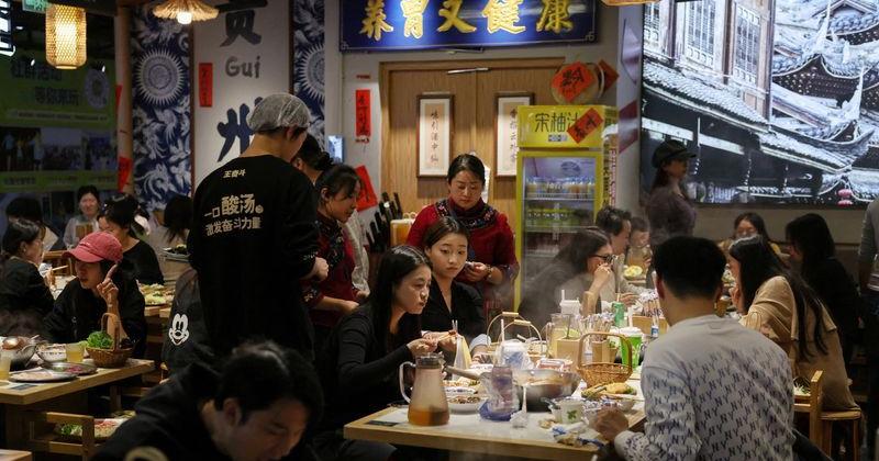 Customers dine at a restaurant in Beijing