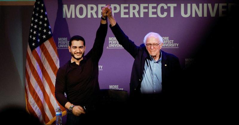 Democratic US Senate nominee Abdul El-Sayed and US Senator Bernie Sanders (I-VT) join hands at a More Perfect University Presents Students vs Billionaires Town Hall