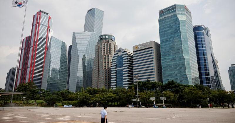 An employee walks at an empty park near a financial district amid the coronavirus disease (COVID-19) pandemic in Seoul